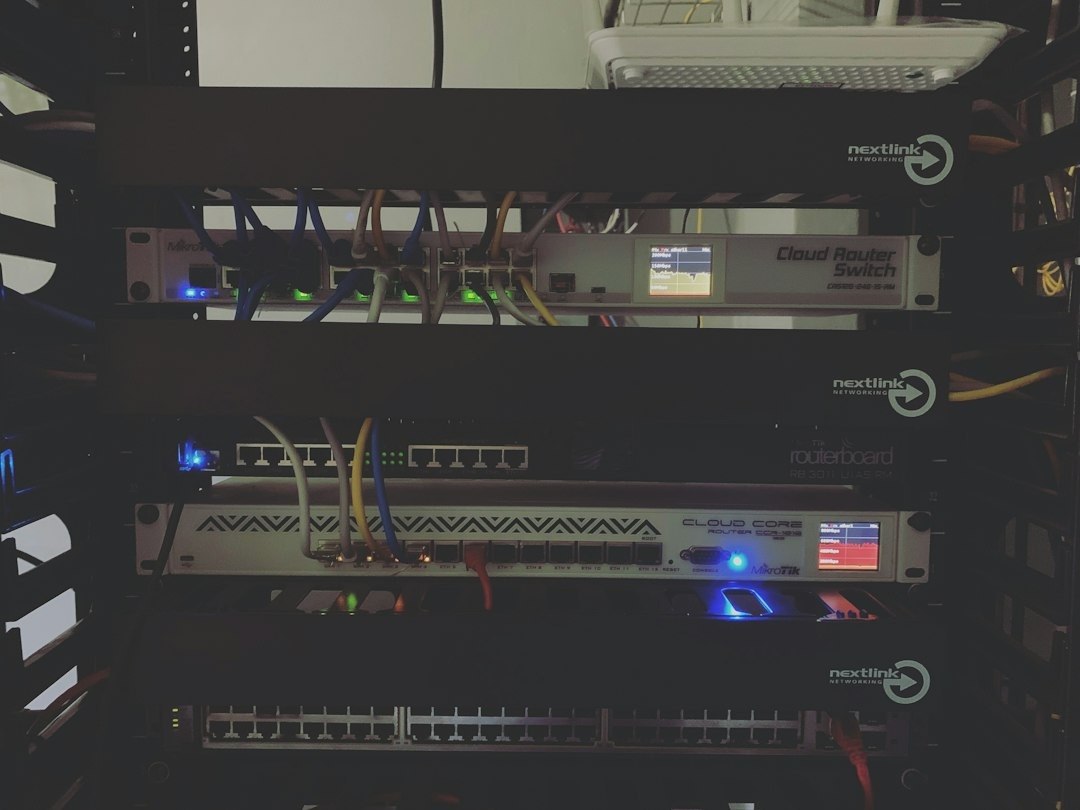 Server rack with active networking equipment and colorful cables.